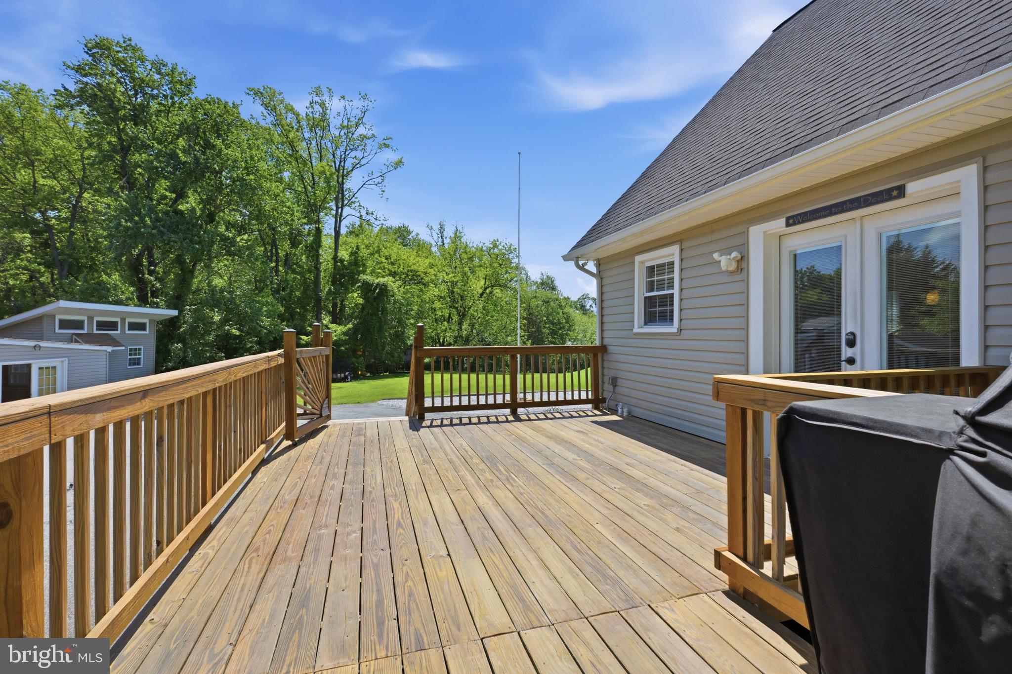 768 Salem Church Road Newark, DE 19702 - Photo 7 of 42 Sunny deck with lush green backdrop.