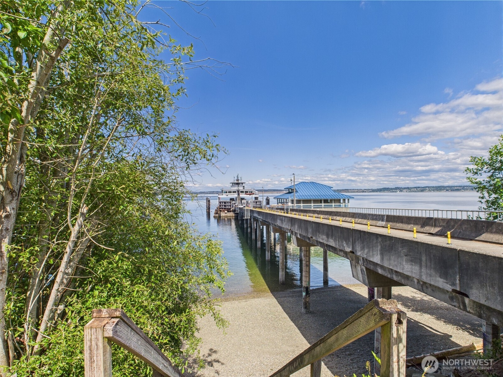 10412 Edgewood Drive Anderson Island, WA 98303 - Photo 13 of 16 a view of a balcony with wooden chairs and wooden fence
