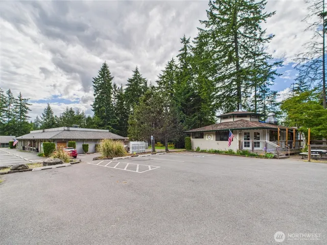 a view of a house with a yard and sitting area