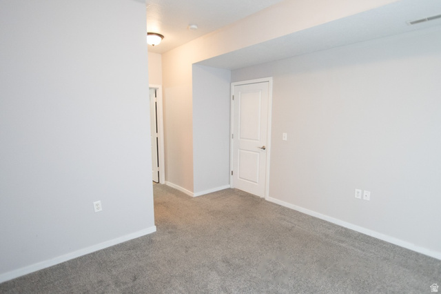 2150 South Main Street, Unit R405 Salt Lake City, UT 84115 - Photo 15 of 20 Spacious room featuring neutral grey carpeting and light grey wall paint