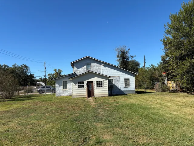 a front view of a house with a garden and yard