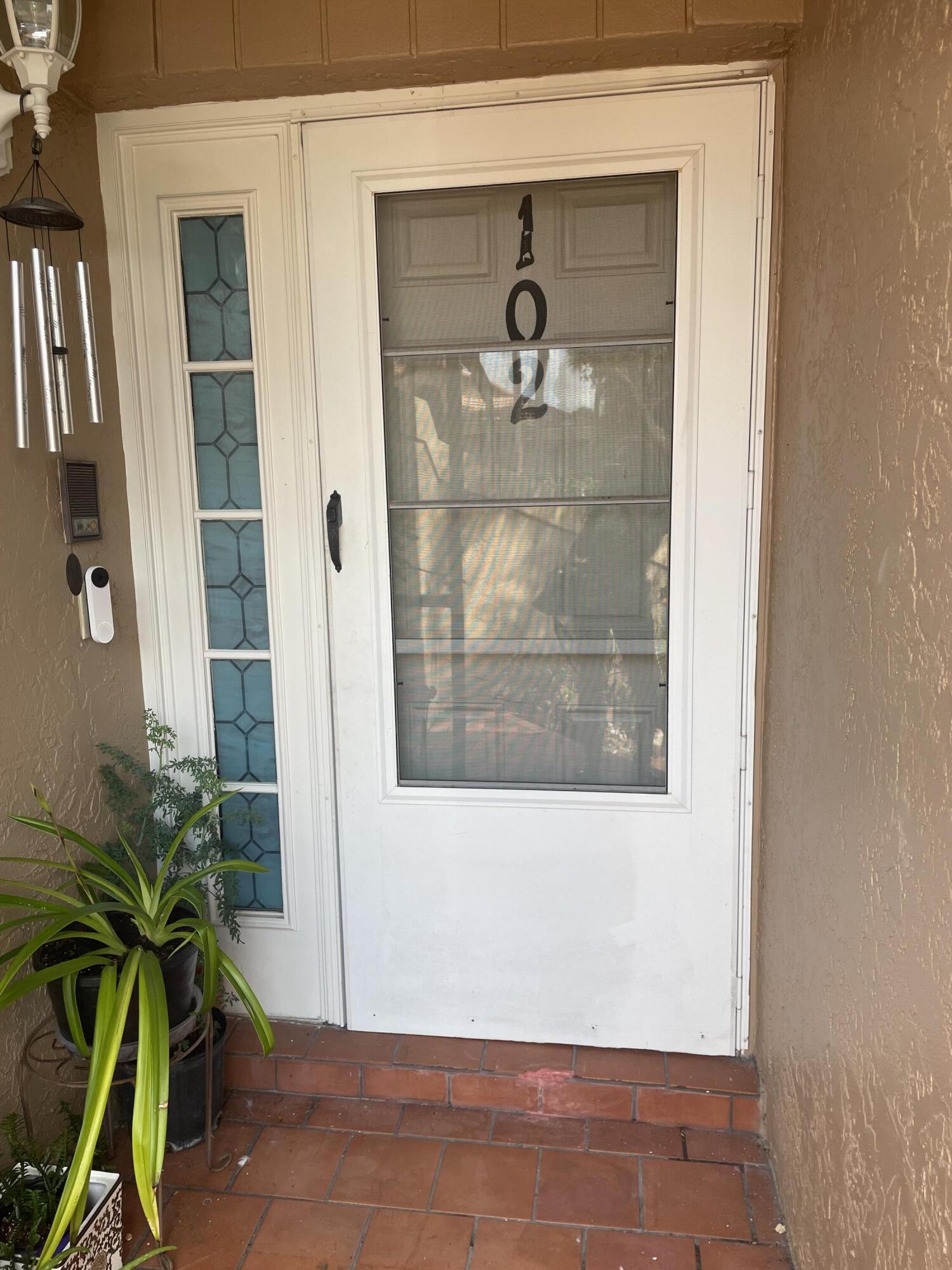 18258 Covina Way, Unit 102 Boca Raton, FL 33498 - Photo 2 of 14 a view of a glass door