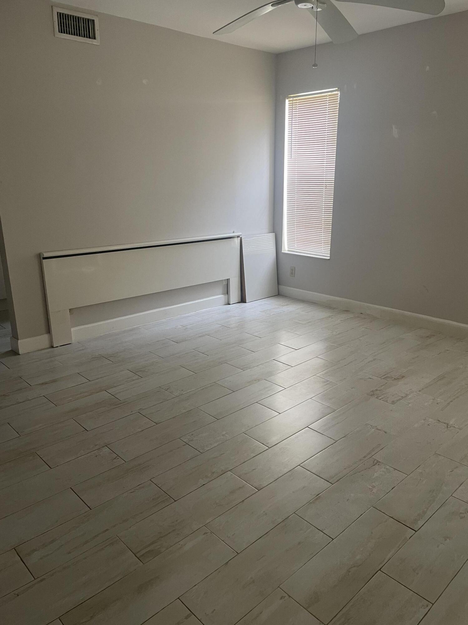 18258 Covina Way, Unit 102 Boca Raton, FL 33498 - Photo 6 of 14 a view of an empty room and window