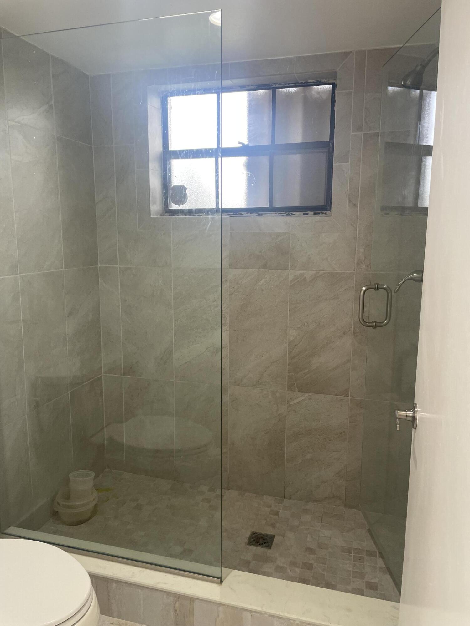 18258 Covina Way, Unit 102 Boca Raton, FL 33498 - Photo 8 of 14 a bathroom with a shower and toilet