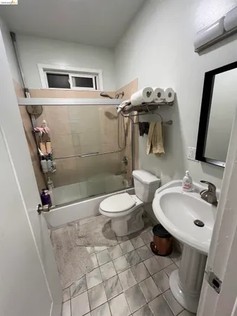 a bathroom with a toilet a sink and mirror