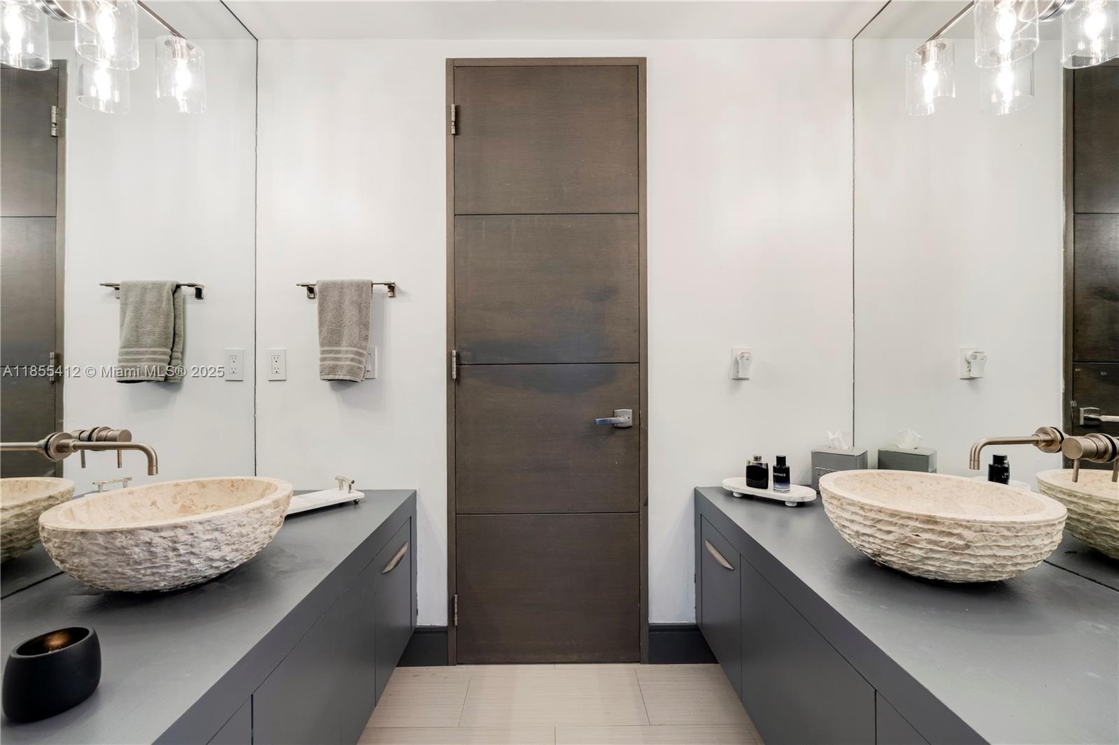 545 Sabal Palm Drive Key Biscayne, FL 33149 - Photo 12 of 100 a bathroom with a tub sink and mirror