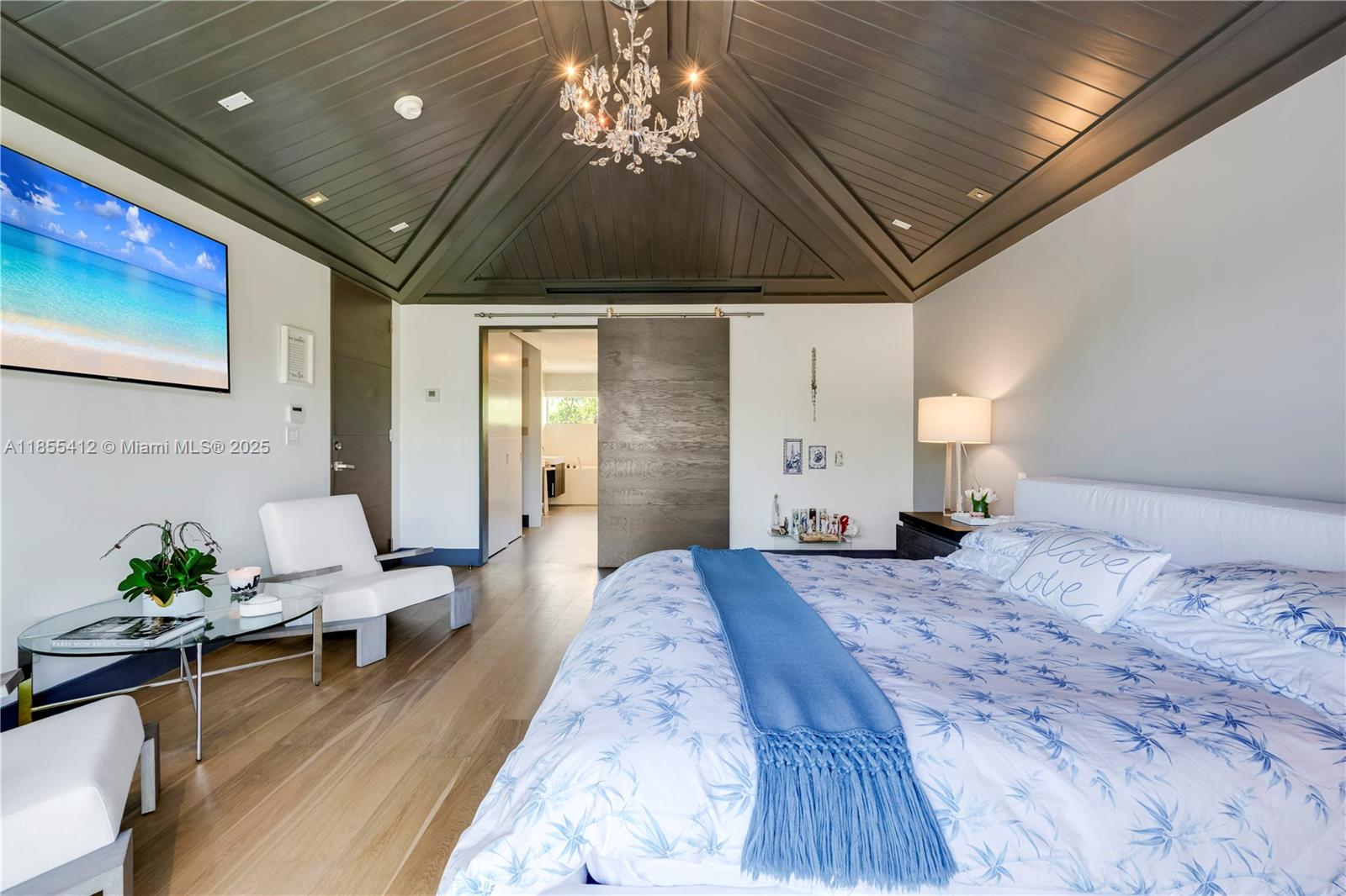 545 Sabal Palm Drive Key Biscayne, FL 33149 - Photo 16 of 100 a spacious bedroom with a bed and a chandelier