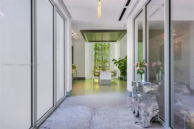 a living room with furniture a wooden floor and a chandelier