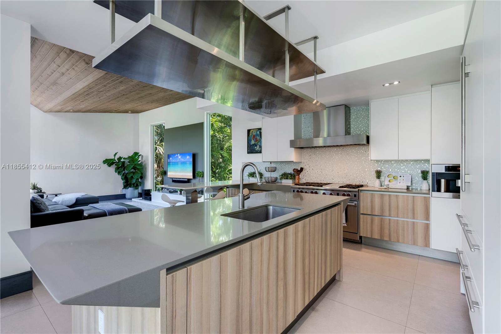 545 Sabal Palm Drive Key Biscayne, FL 33149 - Photo 18 of 100 a kitchen with stainless steel appliances granite countertop a sink a stove and a wooden cabinets