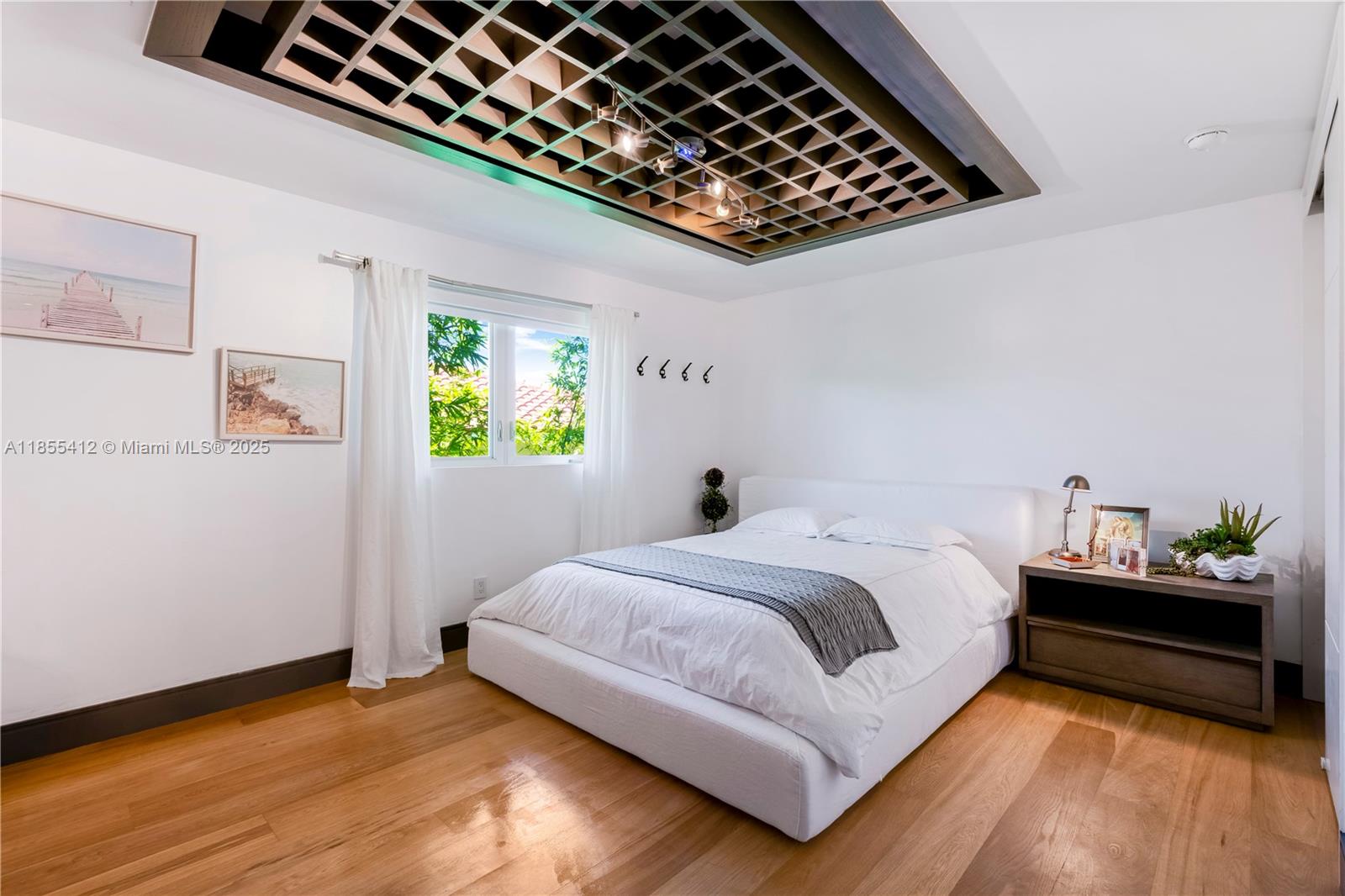 545 Sabal Palm Drive Key Biscayne, FL 33149 - Photo 28 of 100 a bedroom with a bed and wooden floor