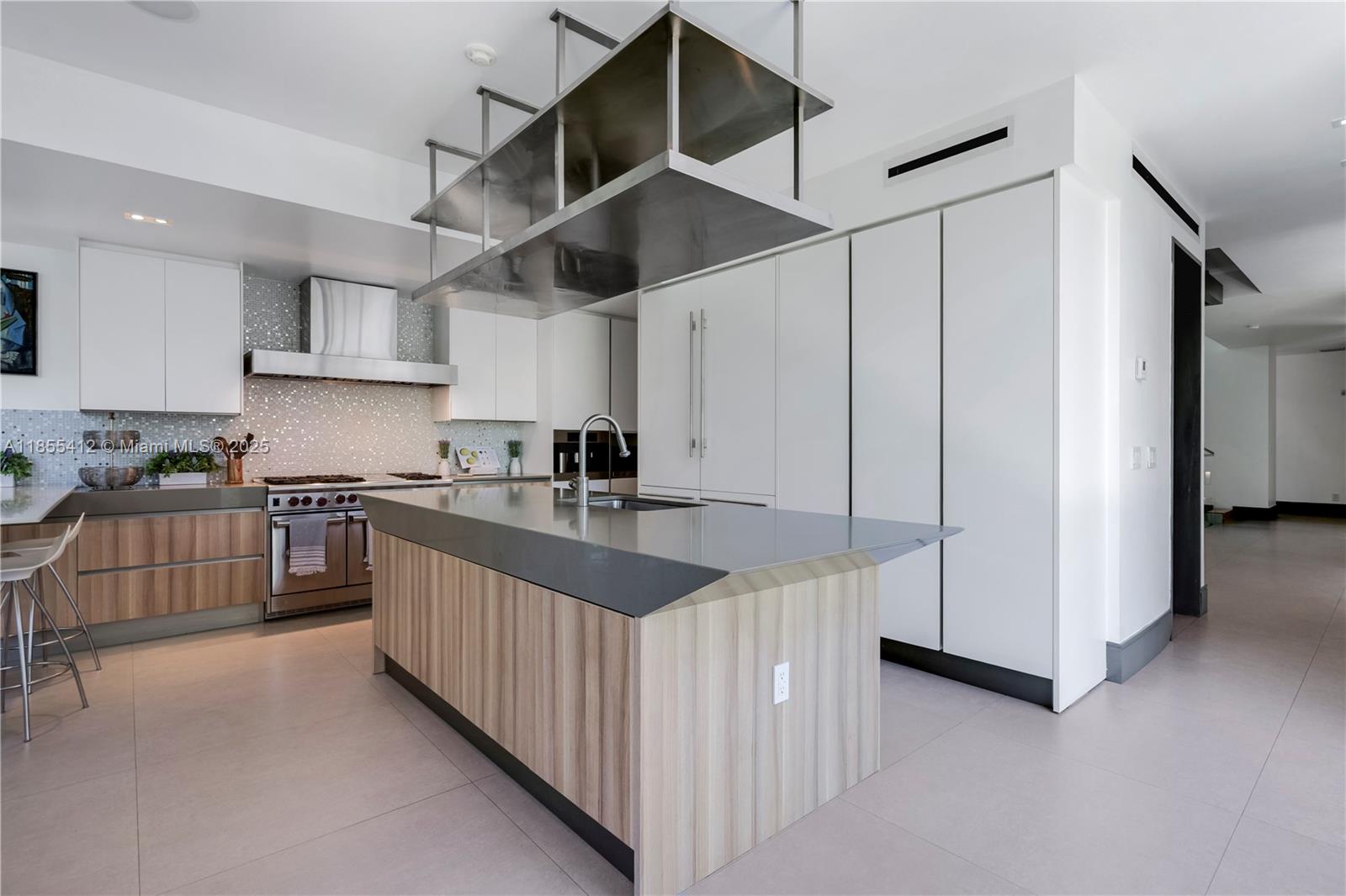545 Sabal Palm Drive Key Biscayne, FL 33149 - Photo 30 of 100 a kitchen with stainless steel appliances granite countertop a sink and cabinets