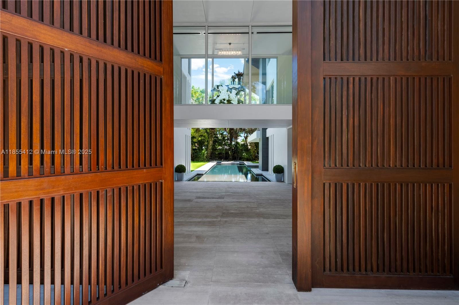 545 Sabal Palm Drive Key Biscayne, FL 33149 - Photo 3 of 100 a view of a porch with a yard