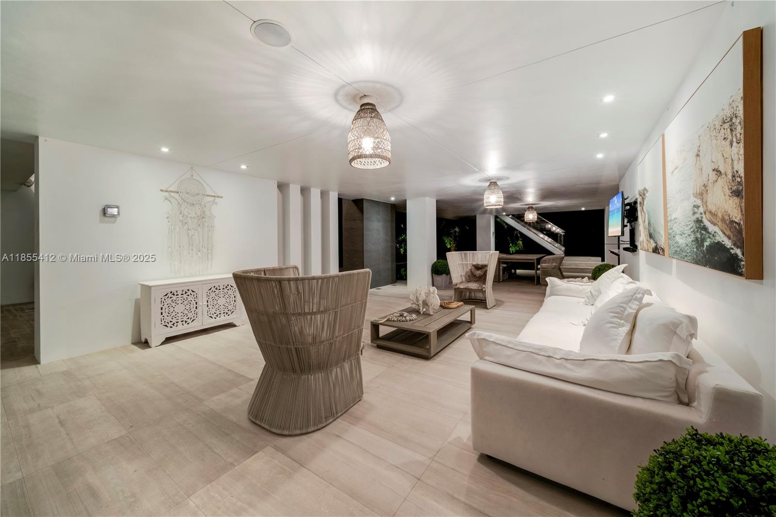 545 Sabal Palm Drive Key Biscayne, FL 33149 - Photo 33 of 100 a living room with furniture a wooden floor and a chandelier