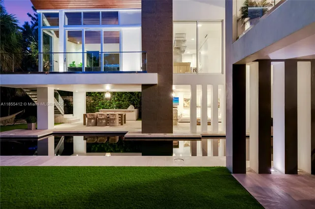 a view of a house with swimming pool and sitting area