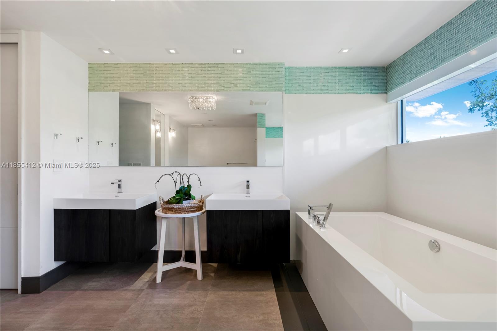 545 Sabal Palm Drive Key Biscayne, FL 33149 - Photo 40 of 100 a bathroom with a bathtub a sink a mirror and a shower