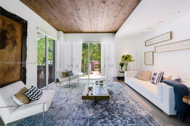 a bathroom with a granite countertop sink a toilet a mirror and shower