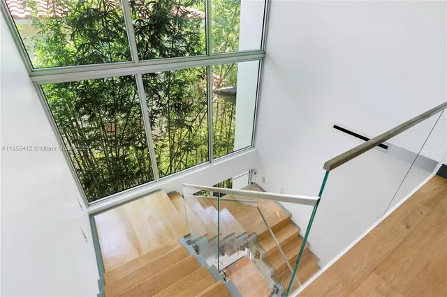 a kitchen with stainless steel appliances granite countertop a stove a sink and a granite counter tops with white cabinets