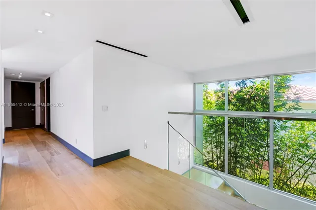 a view of an apartment with a table and chairs and potted plants