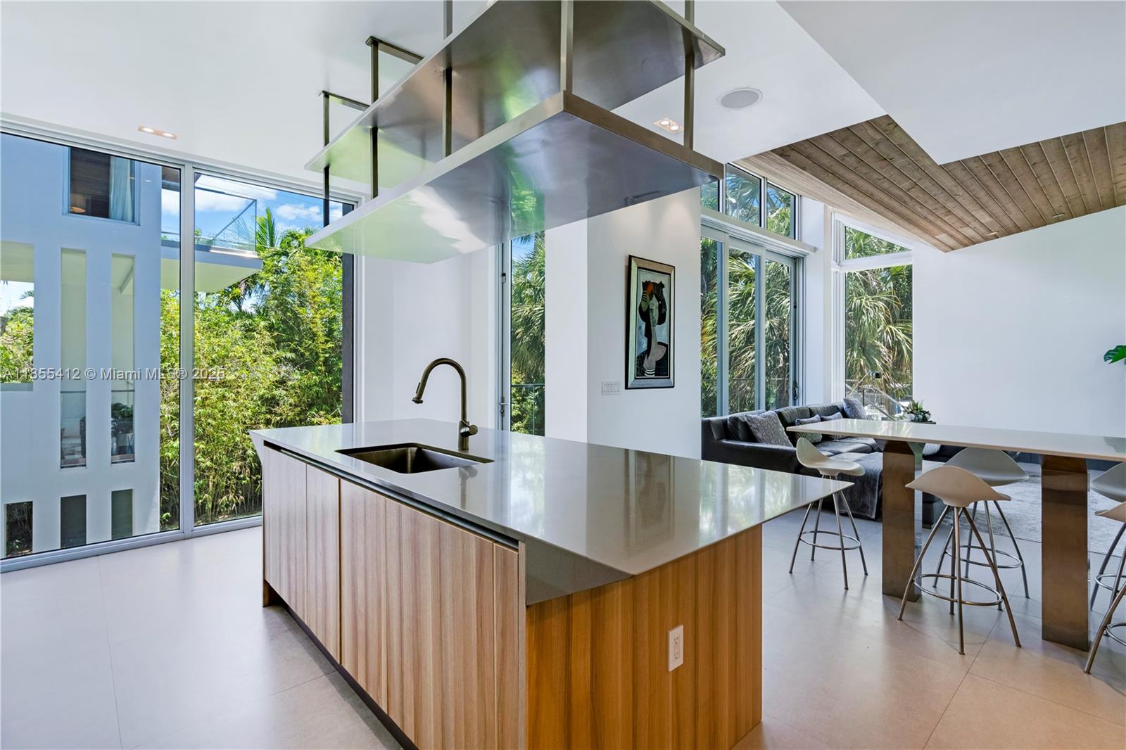 545 Sabal Palm Drive Key Biscayne, FL 33149 - Photo 52 of 100 a kitchen with sink a stove and chairs with wooden floor