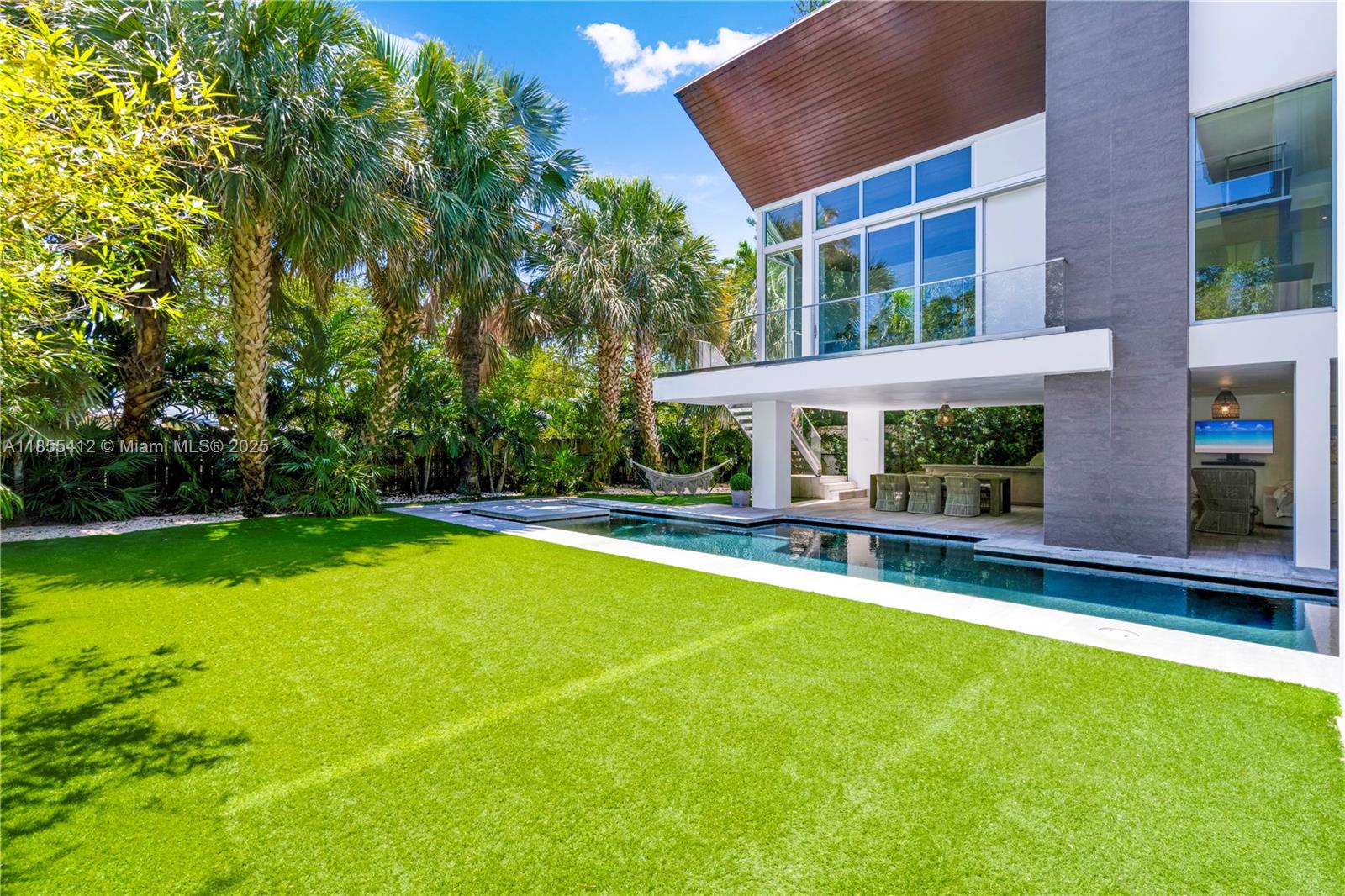 545 Sabal Palm Drive Key Biscayne, FL 33149 - Photo 61 of 100 a view of house with swimming pool yard and outdoor seating