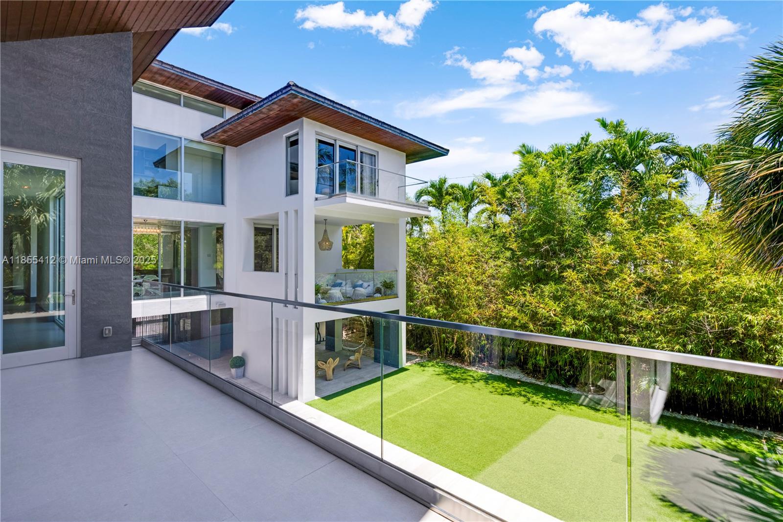 545 Sabal Palm Drive Key Biscayne, FL 33149 - Photo 67 of 100 a view of a house with swimming pool and sitting area