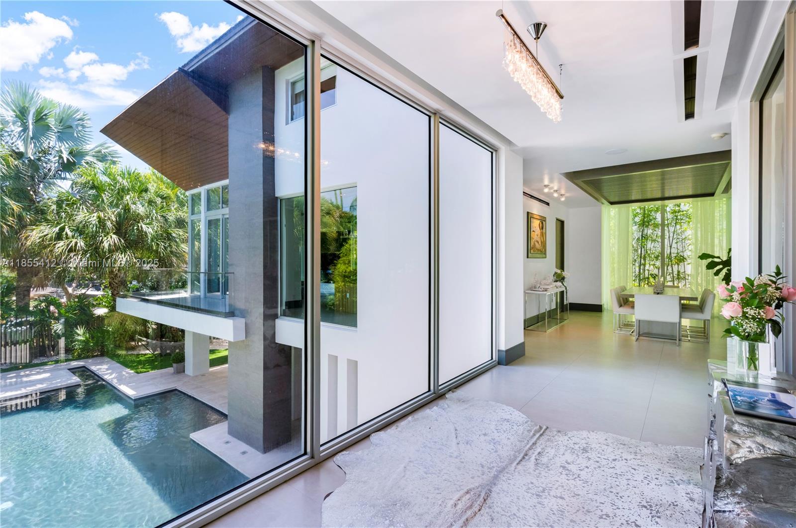 545 Sabal Palm Drive Key Biscayne, FL 33149 - Photo 70 of 100 a view of a porch with chairs and potted plants