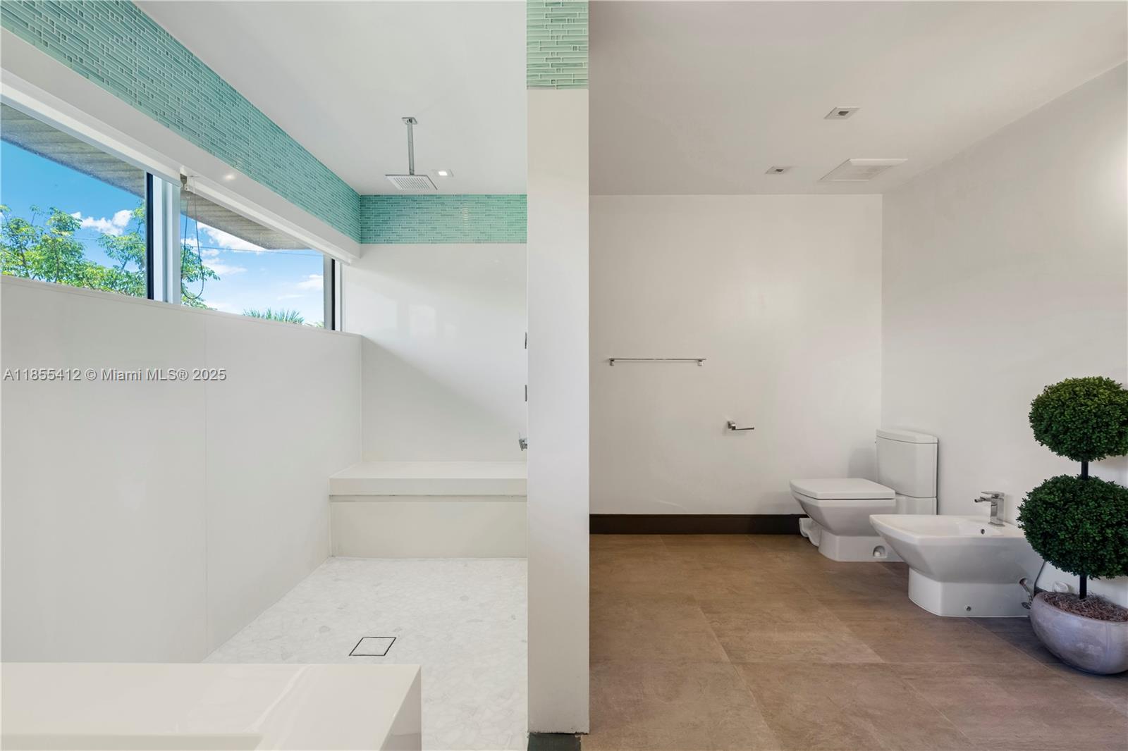 545 Sabal Palm Drive Key Biscayne, FL 33149 - Photo 71 of 100 a bathroom with a toilet sink and tub