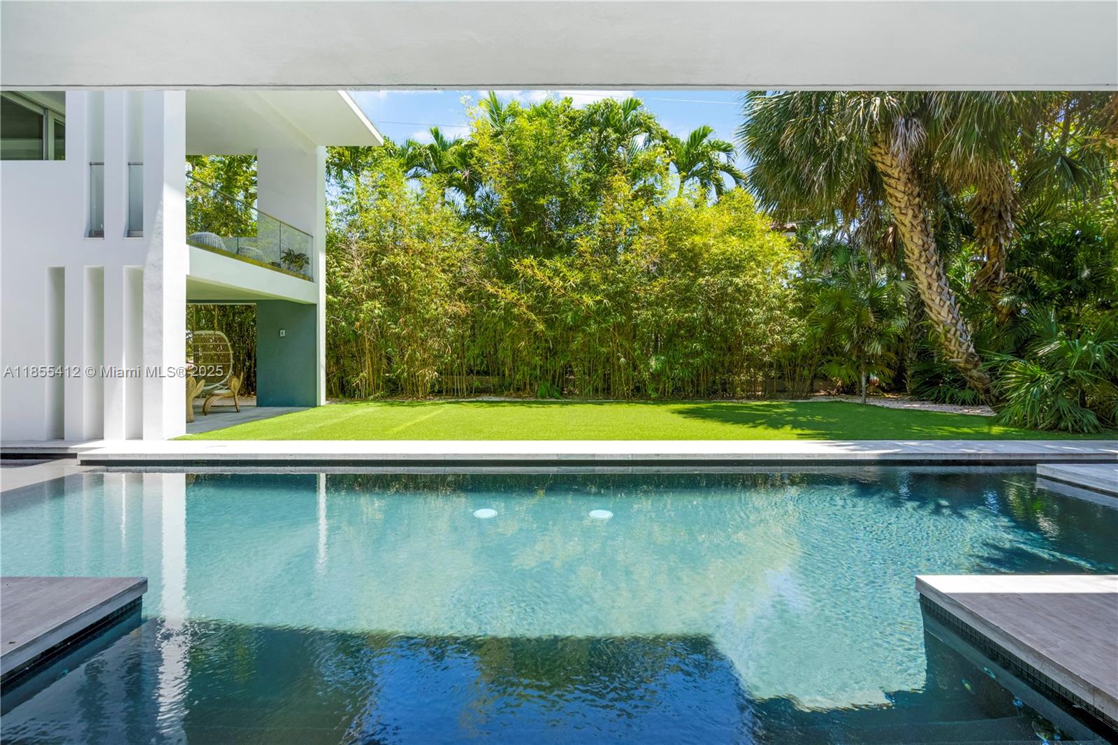 545 Sabal Palm Drive Key Biscayne, FL 33149 - Photo 72 of 100 a view of a swimming pool and outdoor space