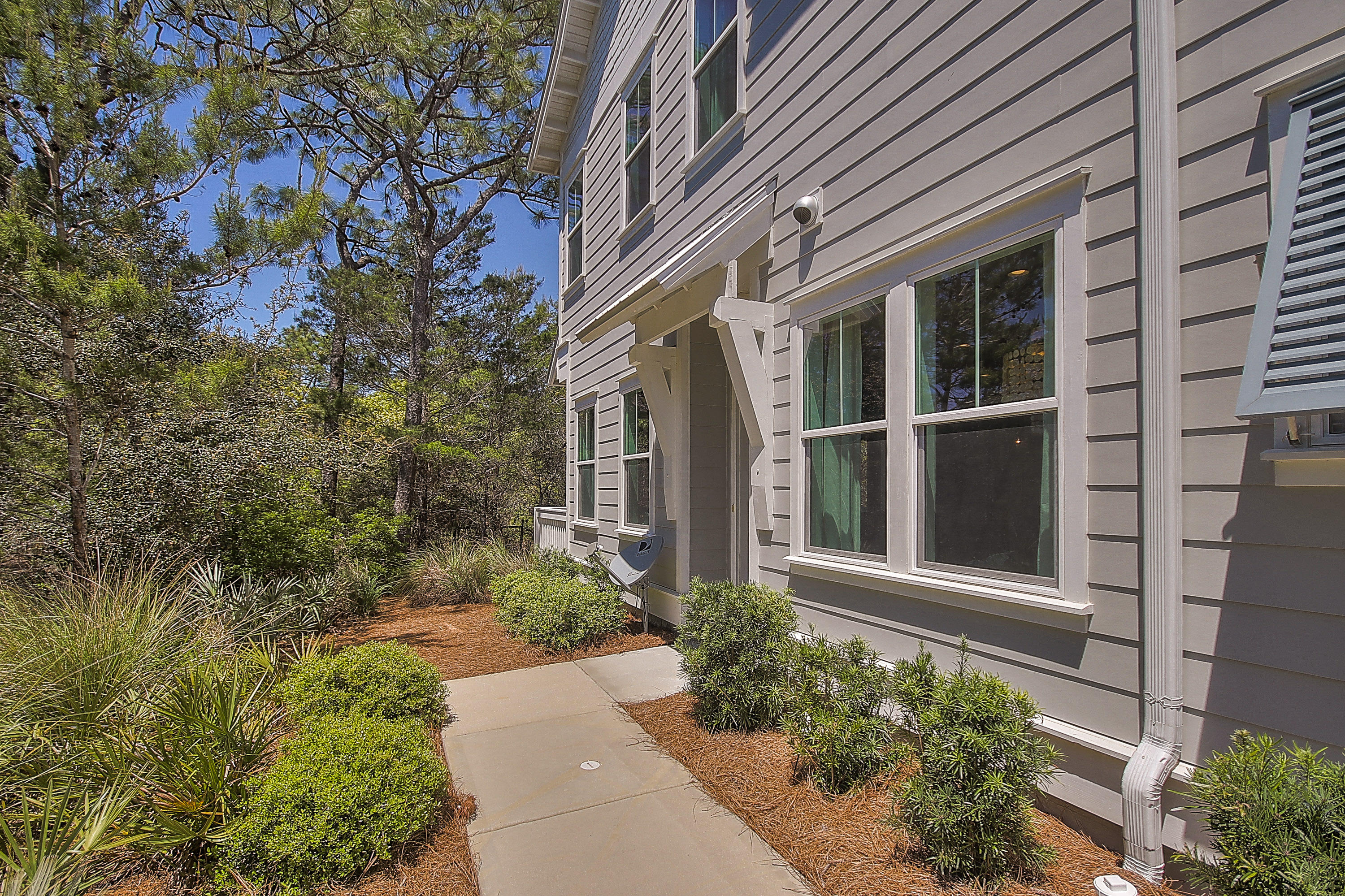167 Milestone Drive, Unit A Inlet Beach, FL 32461 - Photo 3 of 47 front view of a brick house with a yard