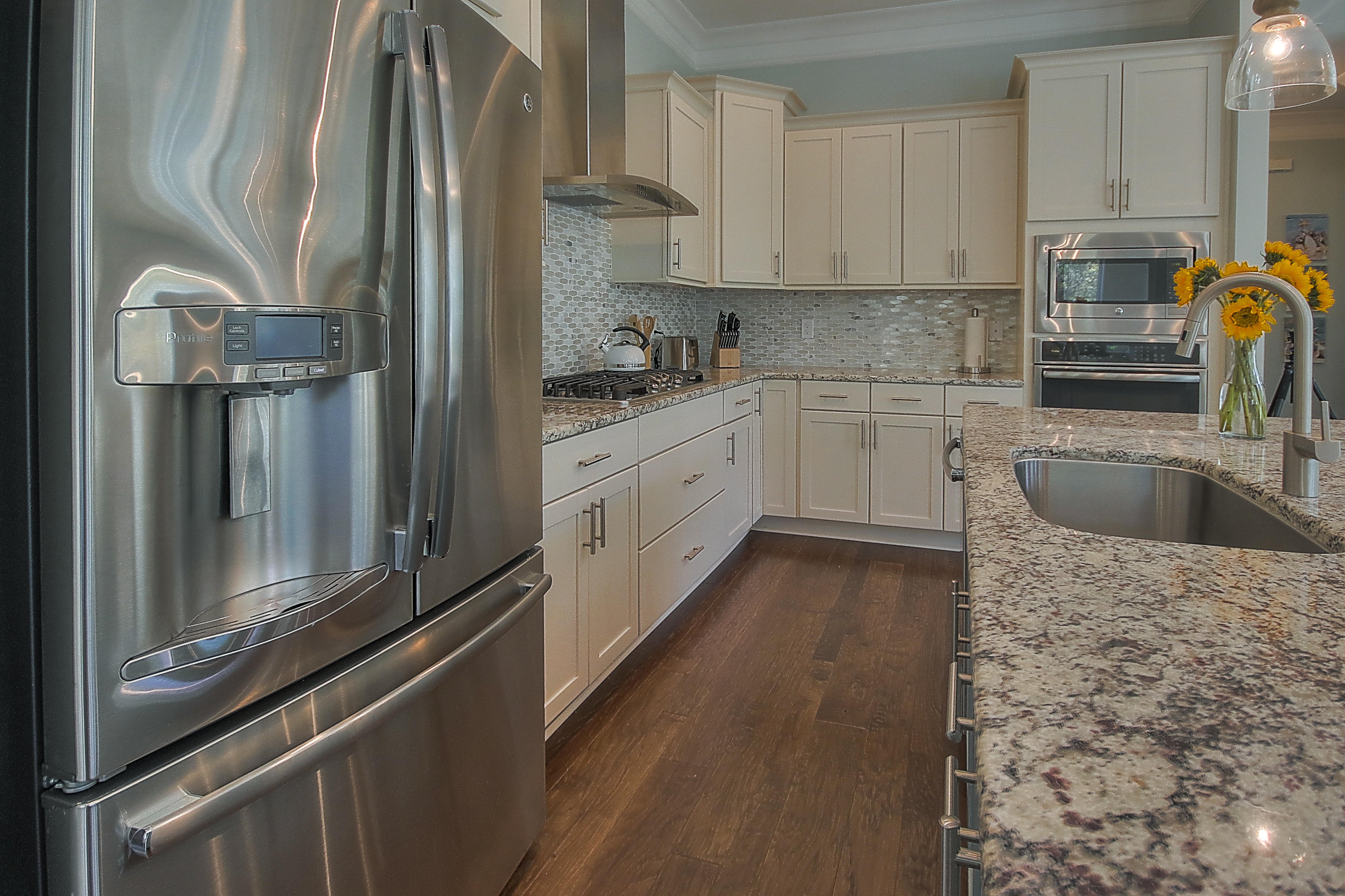 167 Milestone Drive, Unit A Inlet Beach, FL 32461 - Photo 5 of 47 a kitchen with stainless steel appliances granite countertop a refrigerator a sink and white cabinets