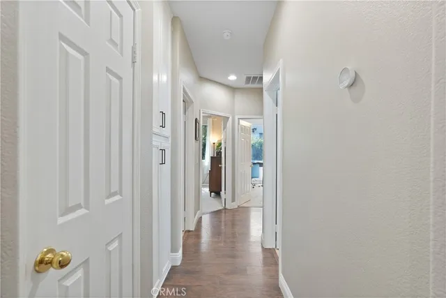 a view of hallway with closet and mirror