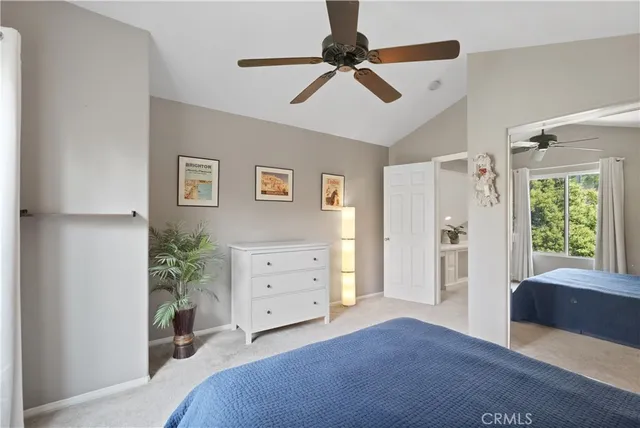 a bedroom with a bed and a potted plant