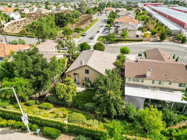 an aerial view of residential houses with outdoor space and street view