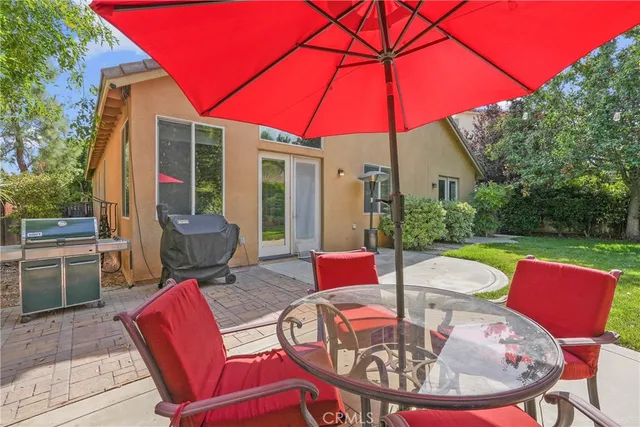 a view of a patio with a table chairs and a patio