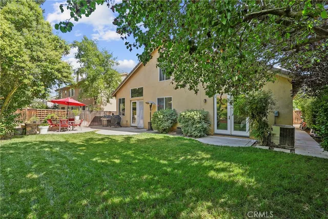 a view of a house with a yard and sitting area