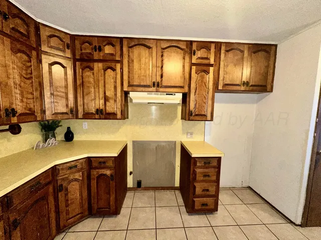 a bathroom with a granite countertop sink a mirror a vanity and a shower