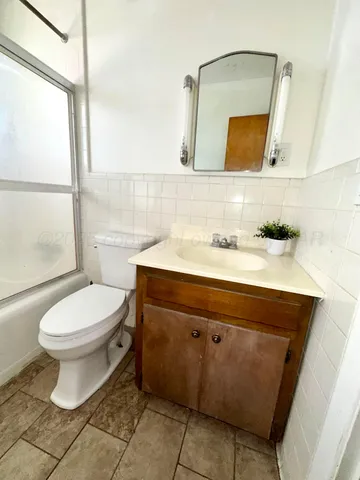 a bathroom with a sink a toilet and mirror