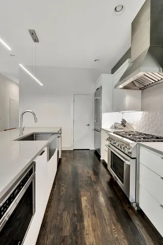 a kitchen with a stove and a refrigerator