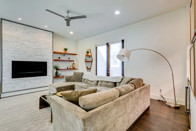 a living room with furniture and a wooden floor