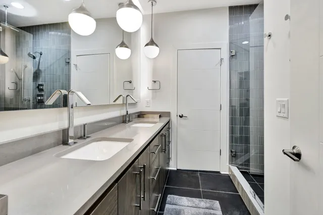 a en suite bathroom with a double vanity sink and a mirror