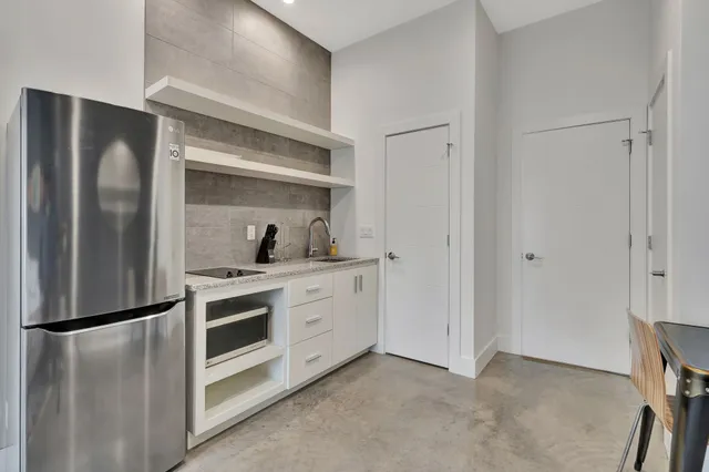 a kitchen with stainless steel appliances a refrigerator sink and cabinets