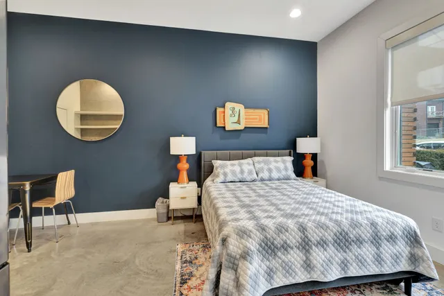 a bedroom with a bed and a chair