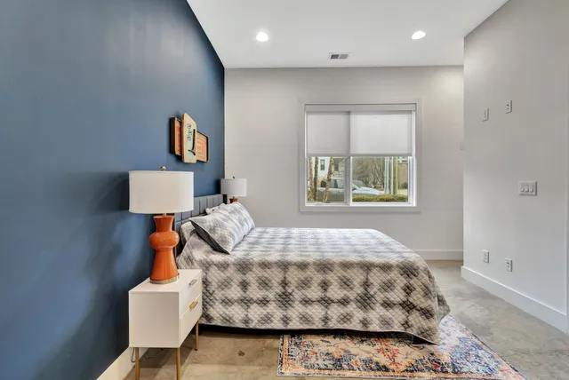 a bedroom with a bed and a window