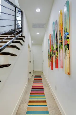 a view of a hallway with lots of stuff and white walls