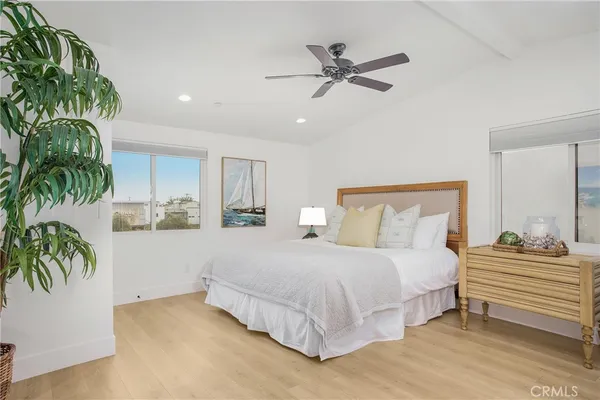 a bedroom with a bed and a potted plant