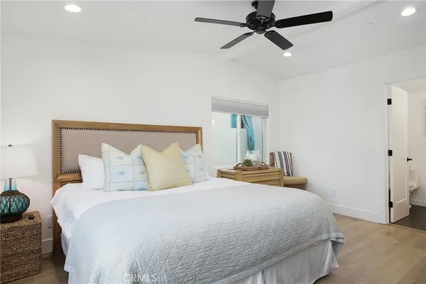 a bedroom with a bed and ceiling fan