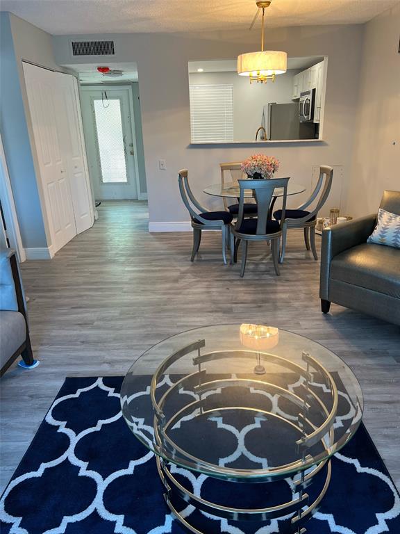 9070 Lime Bay Boulevard, Unit 209 Tamarac, FL 33321 - Photo 12 of 27 a room with furniture and wooden floor