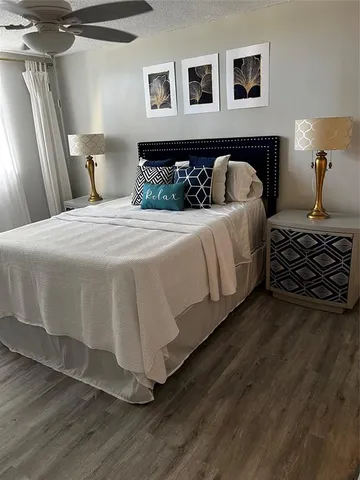 a bedroom with a bed next to a window with the outer view