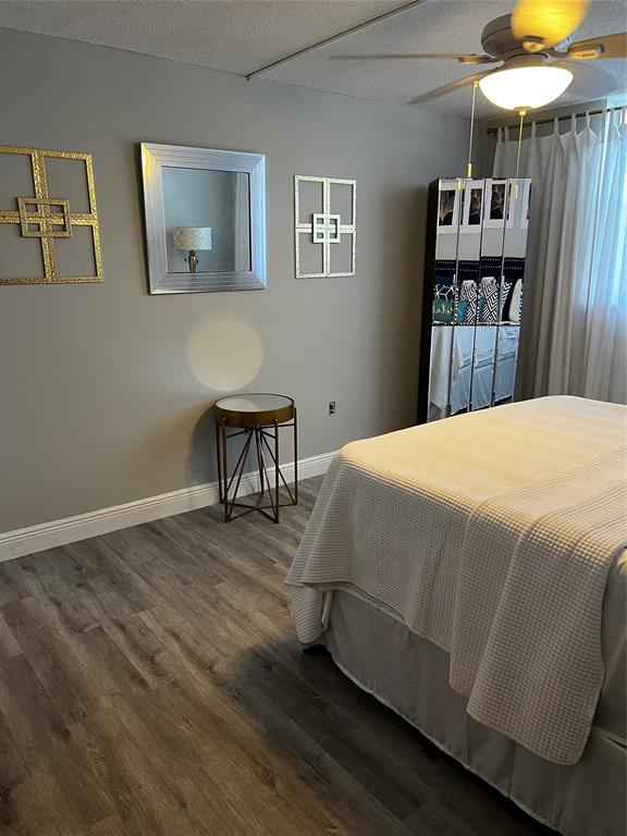 9070 Lime Bay Boulevard, Unit 209 Tamarac, FL 33321 - Photo 15 of 27 a bedroom with a bed and a chair