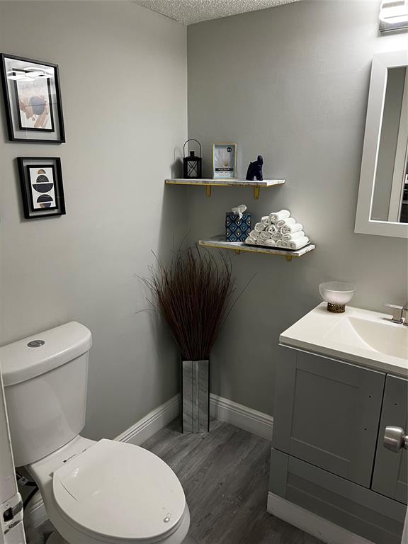 9070 Lime Bay Boulevard, Unit 209 Tamarac, FL 33321 - Photo 18 of 27 a bathroom with a toilet a sink and mirror